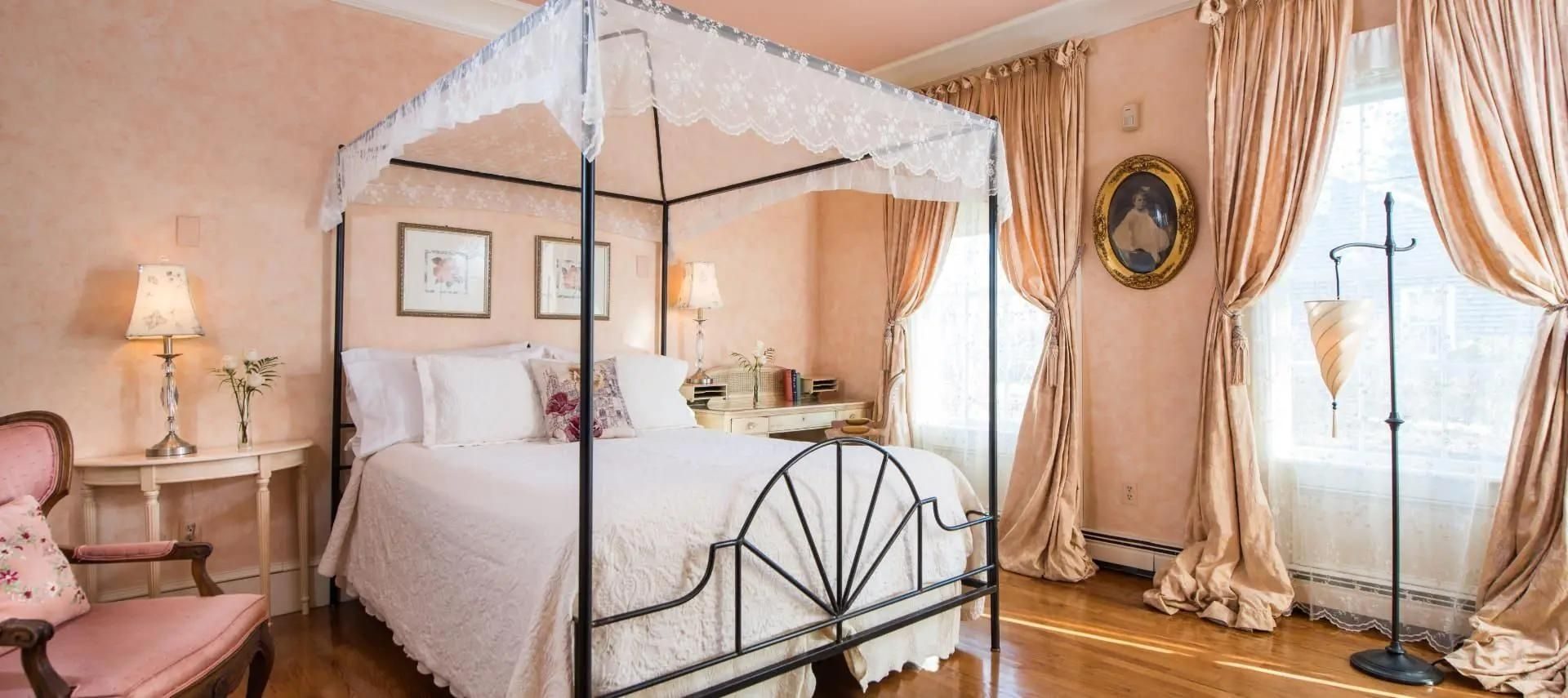 Stunning guest suite in cream and peach with canopy bed and luxurious drapes
