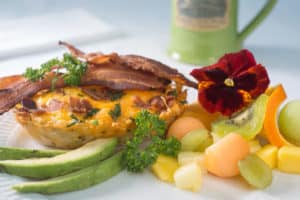 plate of has brown egg nests and fruit