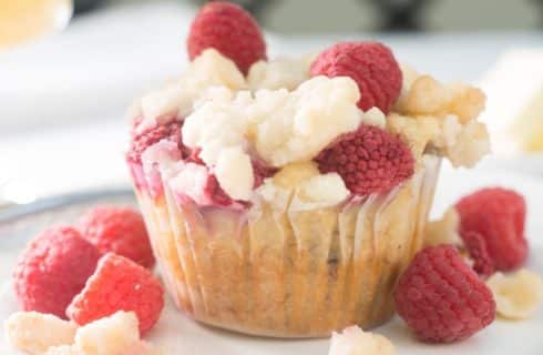 Muffin topped with crumbles and raspberries